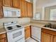 Well-maintained kitchen featuring a sink, oven and dishwasher with natural lighting at 211 Providence Glen, Chapel Hill, NC 27514