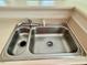 A double-basin stainless steel kitchen sink with a chrome faucet and soap dispenser at 211 Providence Glen, Chapel Hill, NC 27514