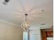 Living room boasts an elegant chandelier and white ceilings, enhanced by natural light for a warm ambiance at 211 Providence Glen, Chapel Hill, NC 27514