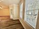 Open living room with hardwood floors, two windows, and neutral paint throughout at 211 Providence Glen, Chapel Hill, NC 27514