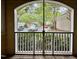 View from the screened-in porch shows a glimpse of the community parking, creating a relaxed outdoor experience at 211 Providence Glen, Chapel Hill, NC 27514