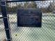 A close-up of a plaque describing the tennis court rules for residents and owners at 211 Providence Glen, Chapel Hill, NC 27514