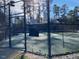 A view through the fence of a gated tennis court at 211 Providence Glen, Chapel Hill, NC 27514