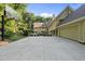 Expansive backyard featuring a concrete patio, basketball court, and lush landscaping at 2207 Vintage Hill Dr, Durham, NC 27712