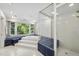 Spacious bathroom with tub, shower, and large window offering backyard views at 2207 Vintage Hill Dr, Durham, NC 27712