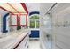 Unique bathroom featuring vibrant decor, a glass shower door, and a large window with natural lighting at 2207 Vintage Hill Dr, Durham, NC 27712
