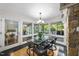 Dining room with glass table, black chairs, and walls of windows offering stunning outdoor views at 2207 Vintage Hill Dr, Durham, NC 27712