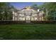 Stunning custom home featuring stone accents, a circular window, and manicured landscaping at 2207 Vintage Hill Dr, Durham, NC 27712