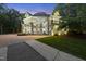 Luxurious home with stone accents and a circular facade, with lush landscaping and a driveway at 2207 Vintage Hill Dr, Durham, NC 27712
