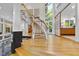 Expansive foyer with curved staircase, wood floors, and modern design elements at 2207 Vintage Hill Dr, Durham, NC 27712