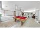 Spacious game room featuring a pool table, spiral staircase, and comfortable seating area at 2207 Vintage Hill Dr, Durham, NC 27712
