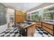 Spacious kitchen featuring an island, stainless steel appliances, and large windows offering scenic views at 2207 Vintage Hill Dr, Durham, NC 27712