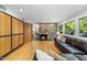 Inviting living room featuring a stone fireplace, hardwood floors, and natural light at 2207 Vintage Hill Dr, Durham, NC 27712