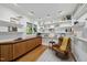 Bright living room features hardwood floors, built-in shelves, and a comfortable chair with a yellow blanket at 2207 Vintage Hill Dr, Durham, NC 27712