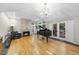 Elegant living room featuring a fireplace, black grand piano, chandelier and light filled windows at 2207 Vintage Hill Dr, Durham, NC 27712
