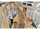 A modern, winding staircase with wood treads and sleek metal railings at 2207 Vintage Hill Dr, Durham, NC 27712