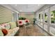 Cozy sunroom with brick floors and multiple windows, perfect for relaxing indoors at 2207 Vintage Hill Dr, Durham, NC 27712