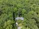 Stunning aerial view of a home nestled in a lush forest, offering privacy and natural beauty at 2306 Damascus Church Rd, Chapel Hill, NC 27516