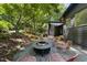 Inviting backyard area featuring a fire pit with chairs, set against a backdrop of mature trees and a wooden deck at 2306 Damascus Church Rd, Chapel Hill, NC 27516