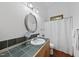 Bathroom with a white shower curtain, wood vanity, and framed mirror at 2306 Damascus Church Rd, Chapel Hill, NC 27516