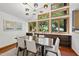Elegant dining room with stylish lighting, built-in storage, and large windows offering serene outdoor views at 2306 Damascus Church Rd, Chapel Hill, NC 27516
