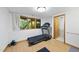A bright exercise room featuring a treadmill, wood floors, and a view of the greenery at 2306 Damascus Church Rd, Chapel Hill, NC 27516