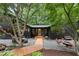 Charming exterior featuring a wooden walkway, gravel patio, and outdoor seating areas at 2306 Damascus Church Rd, Chapel Hill, NC 27516
