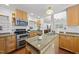 Well-lit kitchen boasting granite countertops, wood cabinetry, stainless steel appliances, and views into the dining room at 2306 Damascus Church Rd, Chapel Hill, NC 27516
