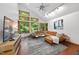 Cozy living room with an L-shaped sofa, large windows, and a modern TV, creating an inviting atmosphere at 2306 Damascus Church Rd, Chapel Hill, NC 27516