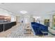 Open-concept living room with sleek black cabinets, a colorful rug, and cozy blue seating at 2306 Damascus Church Rd, Chapel Hill, NC 27516