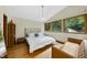 Bright and spacious main bedroom with hardwood floors, large windows, and a comfortable bed at 2306 Damascus Church Rd, Chapel Hill, NC 27516