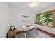 Bright home office with a minimalist desk, large window, and view of the greenery outdoors at 2306 Damascus Church Rd, Chapel Hill, NC 27516