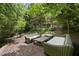 Relaxing outdoor seating area with wicker furniture and a tranquil setting at 2306 Damascus Church Rd, Chapel Hill, NC 27516
