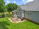 Backyard featuring a stone patio with a fire pit, screened-in porch and lake view at 2419 Rogerson St, Raleigh, NC 27614