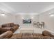 Comfortable basement with couches, wall sconces, and a large television for relaxation and recreation at 2419 Rogerson St, Raleigh, NC 27614