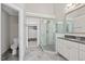 Elegant bathroom boasts walk-in shower with gray and glass tile, marble floor, and custom closet at 2419 Rogerson St, Raleigh, NC 27614