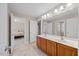 Bathroom boasts double sinks, wooden cabinets, vanity lighting, and access to the Primary bedroom at 2419 Rogerson St, Raleigh, NC 27614