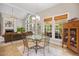 Bright breakfast nook with a glass table set, chandelier lighting, and views of the home's living area at 2419 Rogerson St, Raleigh, NC 27614