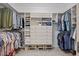 Spacious walk-in closet featuring custom shelving, drawers, and ample storage space for clothes and shoes at 2419 Rogerson St, Raleigh, NC 27614