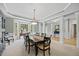 Formal dining room boasts columns, an elegant light fixture, and a bay window for natural light at 2419 Rogerson St, Raleigh, NC 27614