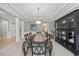 Elegant dining room with decorative molding, a modern light fixture, and stylish furnishings at 2419 Rogerson St, Raleigh, NC 27614
