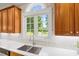 Kitchen sink with a view of the backyard pond and fountain at 2419 Rogerson St, Raleigh, NC 27614
