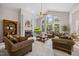 Bright living room with soaring ceilings, large windows, and cozy fireplace at 2419 Rogerson St, Raleigh, NC 27614