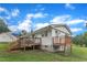 View of a spacious backyard with a wooden deck and a fenced perimeter offering privacy and outdoor relaxation at 2528 Barwick Dr, Durham, NC 27704