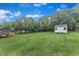 Spacious backyard with lush green grass and mature trees at 2528 Barwick Dr, Durham, NC 27704