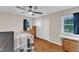 Comfortable bedroom with wood floors, two windows, a ceiling fan, and ample storage at 2528 Barwick Dr, Durham, NC 27704