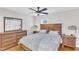 Well-lit bedroom with light wood floors, ceiling fan, and a large bed at 2528 Barwick Dr, Durham, NC 27704