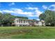 Well-maintained home with a spacious yard, classic white siding, black shutters, and a inviting front porch at 2528 Barwick Dr, Durham, NC 27704