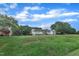 Sprawling front lawn showcases this white home featuring black shutters and a welcoming front entrance with a porch at 2528 Barwick Dr, Durham, NC 27704