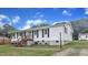 Charming one-story home with white siding, black shutters, and a wooden staircase leading to the front door at 2528 Barwick Dr, Durham, NC 27704